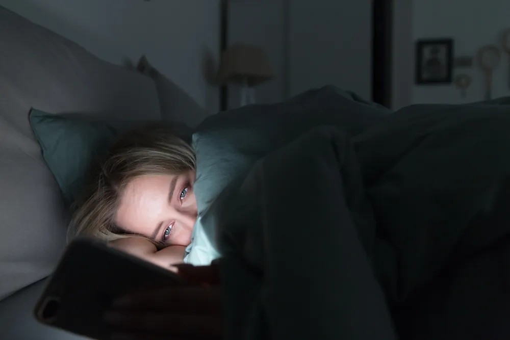 Привычка спать с телефоном приводит к опасным последствиям, предупредил эксперт. Обложка © Shutterstock / FOTODOM