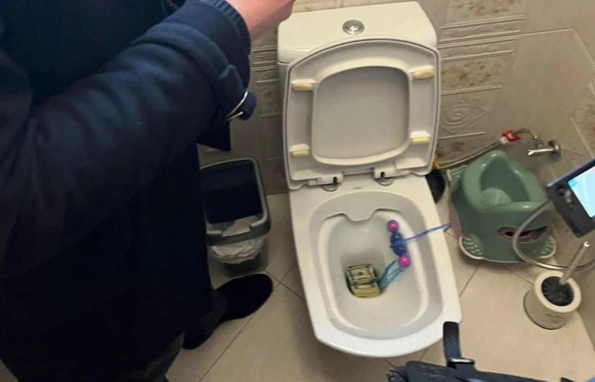 Пачку купюр чиновник пытался смыть в унитаз во время обыска дома. Фото © Telegram / Политика Страны