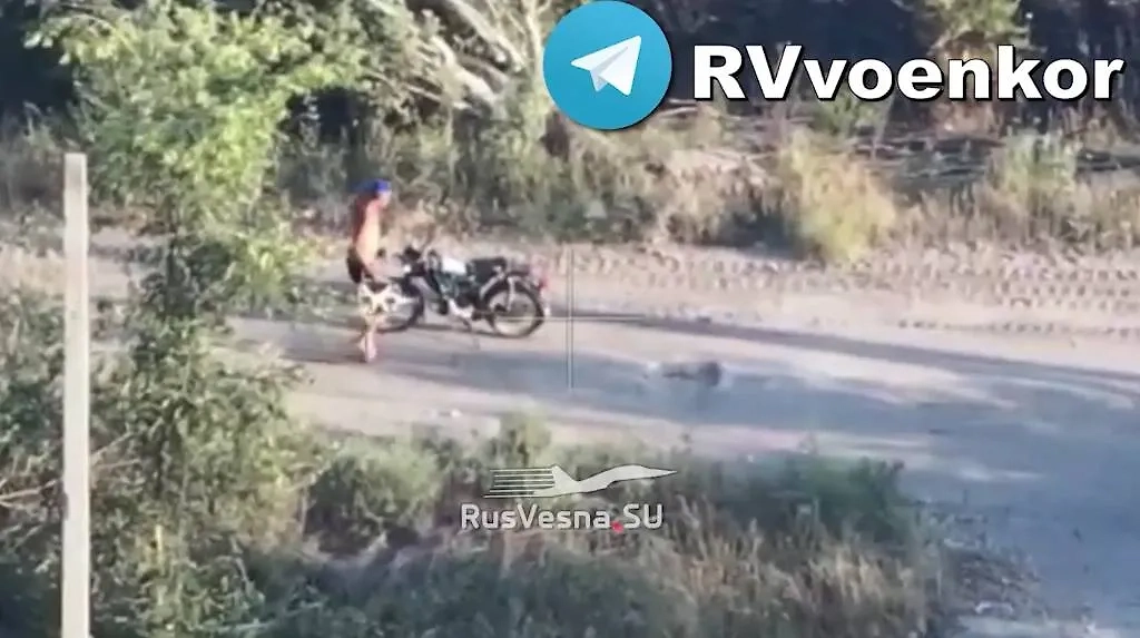 Военнослужащий несёт дрон к мотоциклу. Фото © Telegram / Военкоры русской весны