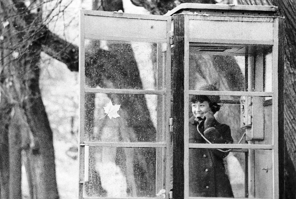 Девушка разговаривает по телефону-автомату, Ленинград, 1968 год. Фото © ТАСС / Юрий Белинский
