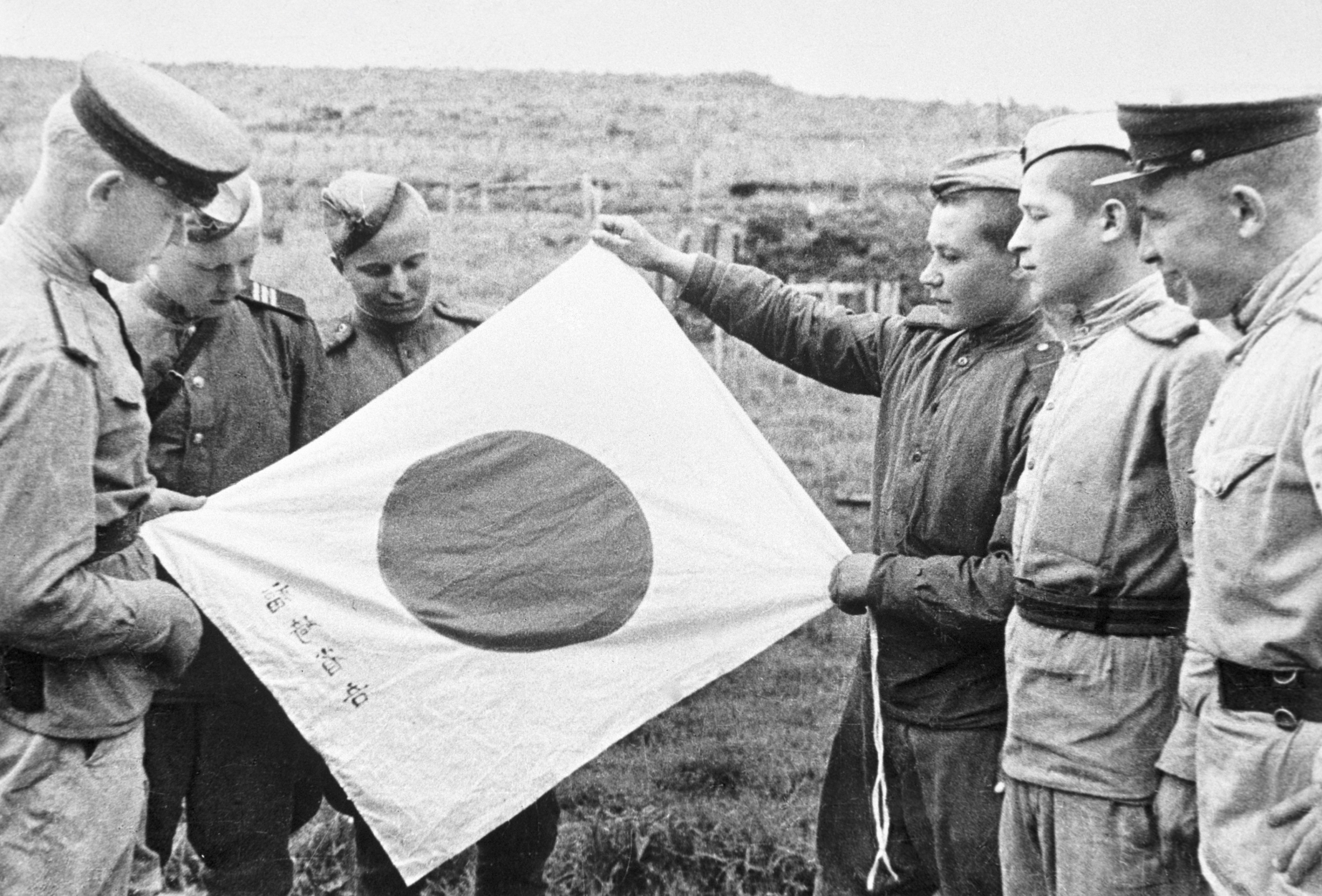 Советские воины рассматривают брошенный японскими солдатами при отступлении национальный флаг. Фото: &copy;РИА Новости