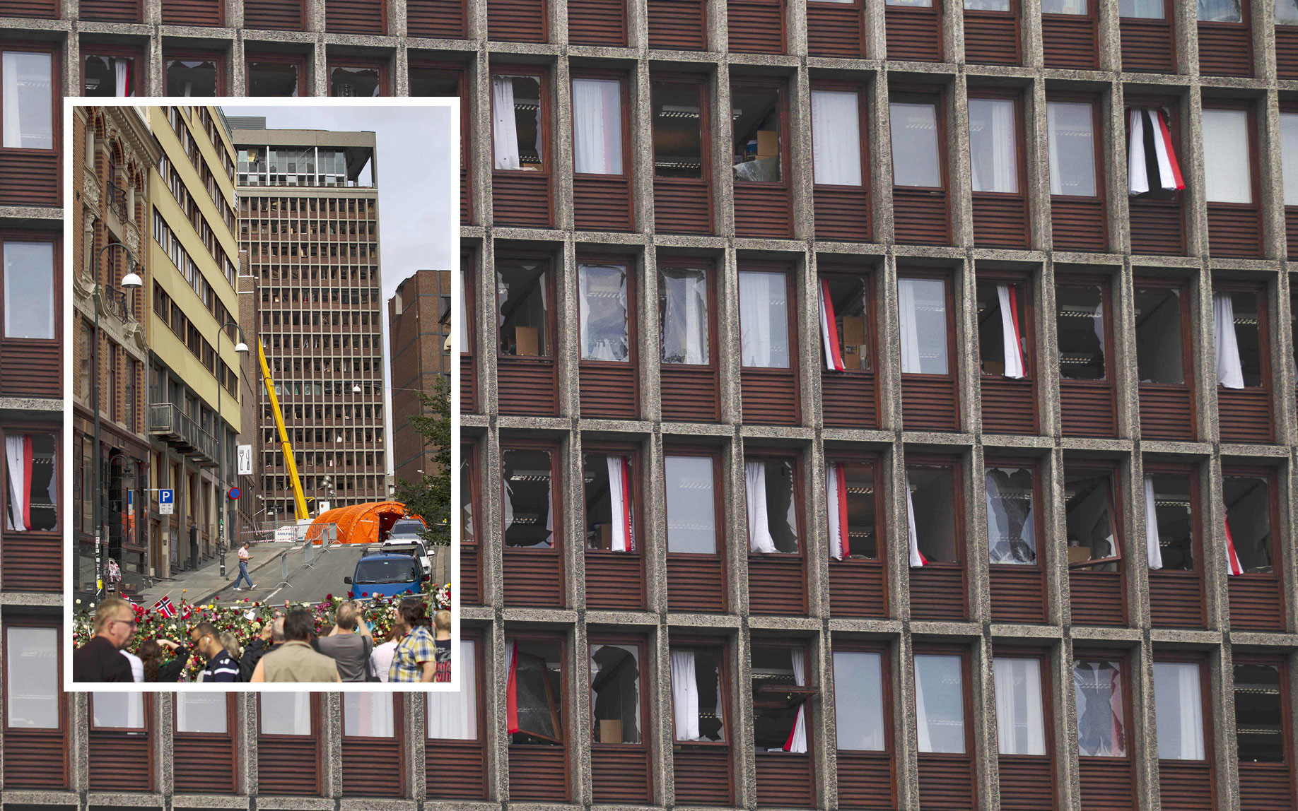 Люди смотрят на здание в оцепленном районе, на взорванные окна, повреждённые в результате бомбардировки. Фото: © AP Photo / Matt Dunham