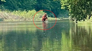 Шокированный каякер снял на видео, как похожее на йети существо бредёт по реке с ребёнком на руках