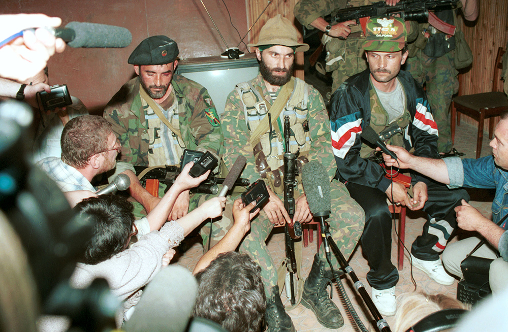 Руководитель террористов Шамиль Басаев (в центре) даёт пресс-конференцию в будённовской больнице 15 июня 1995 года. Фото © ТАСС / Константин Тарусов