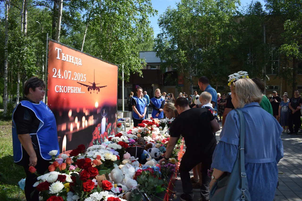 Жители Тынды несут цветы и игрушки к мемориалу в память о жертвах крушения Ан-24